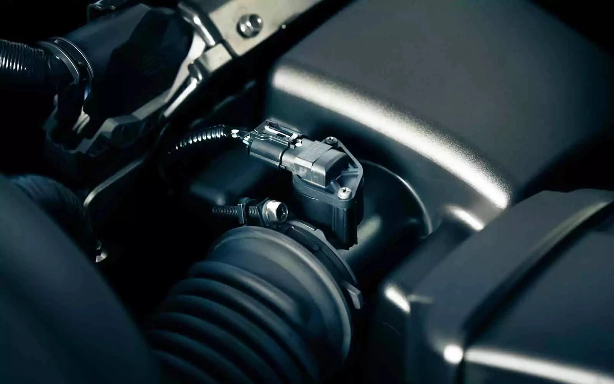 A mass airflow sensor on a spotless engine.