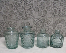 Lot of 4 Light Green Tint Glass Embossed Decorative Bottles - 4" to 3.25" tall