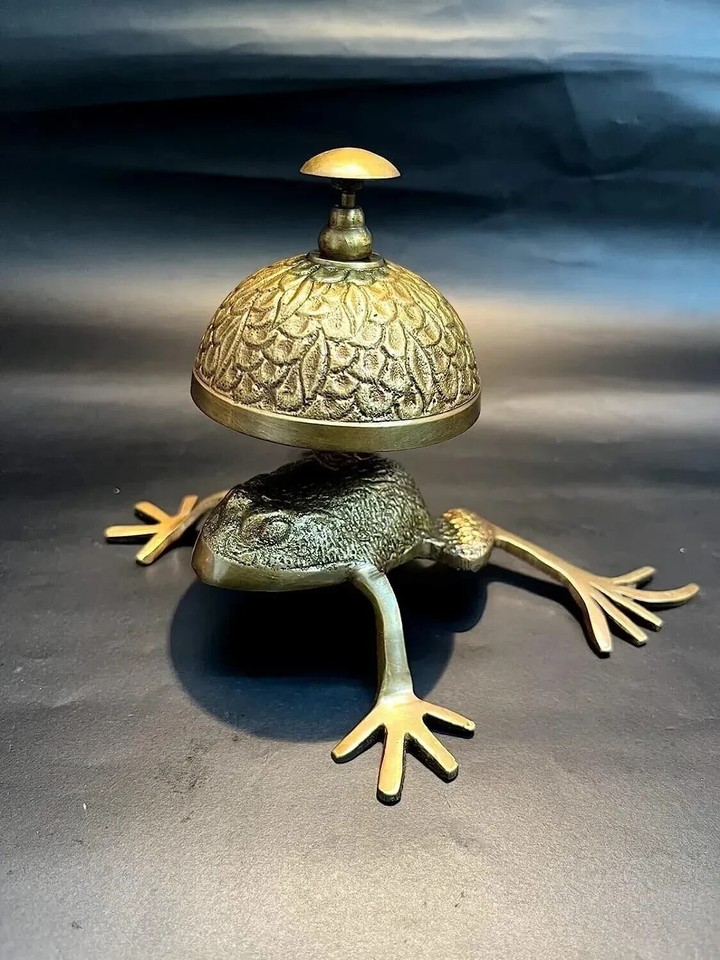 A solid brass nautical frog desk bell — ding it for attention, keep it for the sheer delight of having a frog bell on your desk.