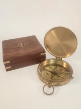 brass compass in wooden box