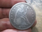 1870 US SEATED LIBERTY SILVER DOLLAR IN FINE CONDITION CLEANED