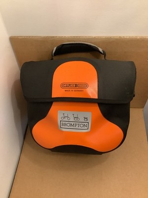 Brompton Faltrad, wasserdichte Ortlieb Mini O Bag schwarz/orange