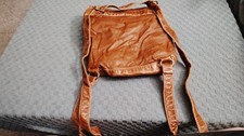Brown shoulder bag with braided accent and po...