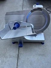 Globe Sir Lawrence manual slicer with 12 inch blade. 115 V. 3 Amps. 1/2HP. 60 Hz