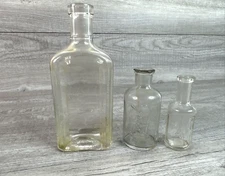Lot of 3 Various Vintage Clear Embossed Bottles Lysol Porters Pain King EW Hoyt