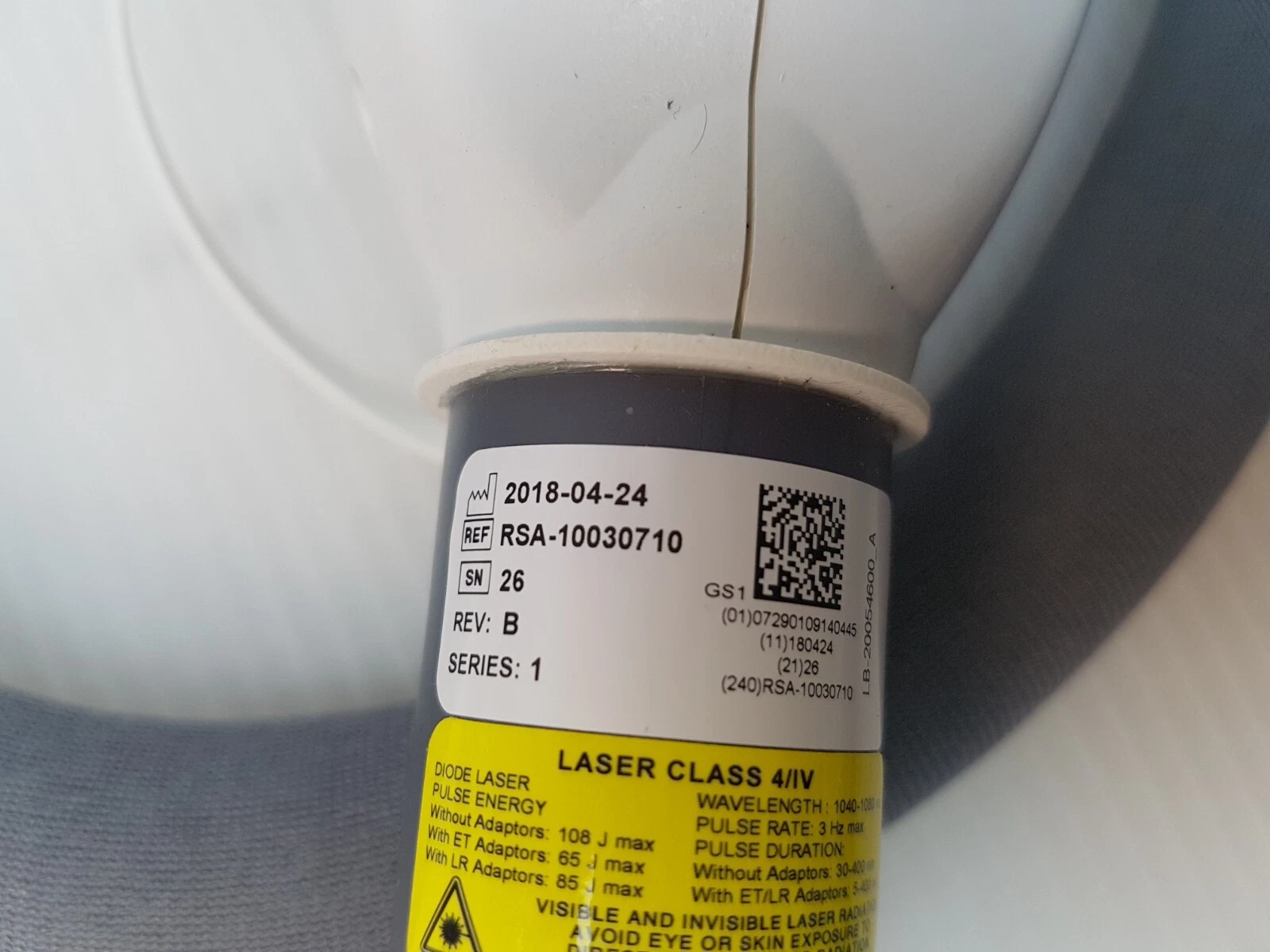 Label REF RSA-10030710 REV B with Class 4 laser ratings and adaptor energies