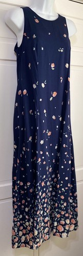 Navy blue sleeveless midi dress with small white floral print, fitted bodice, knee-length skirt, displayed on mannequin.