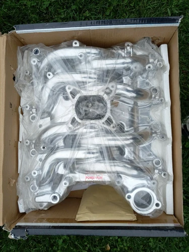 Open box with silver 1999-2004 Ford Mustang 4.6L Professional Products intake manifold, wrapped in clear plastic packaging.