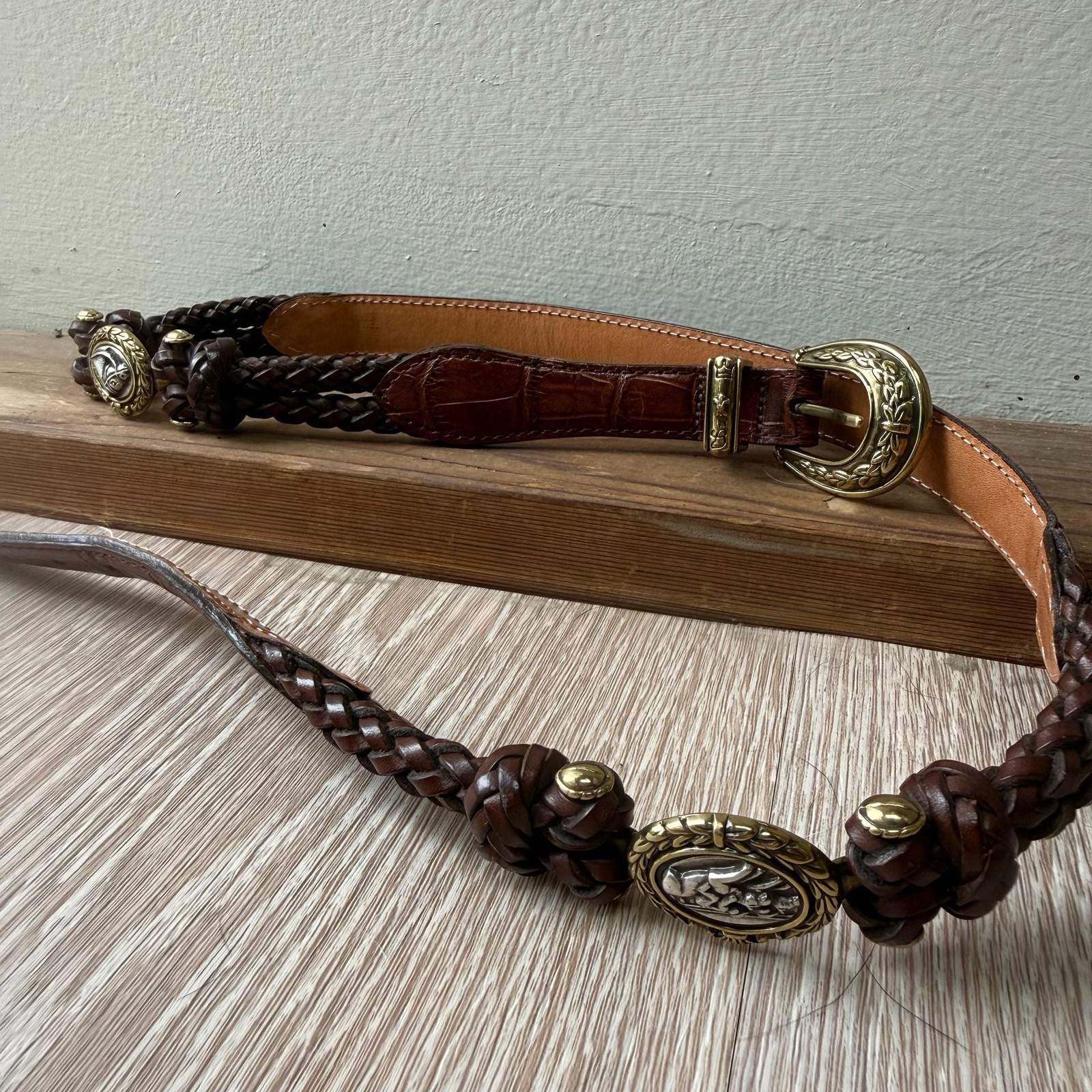 Brown braided Brighton leather belt with an equestrian toggle closure.