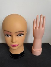Female mannequin head and hand. Plastic display model.