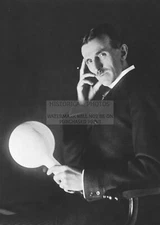 NIKOLA TESLA HOLDING TESLA POWERED LAMP INVENTER, ENGINEER, FUTURIST 5X7 PHOTO