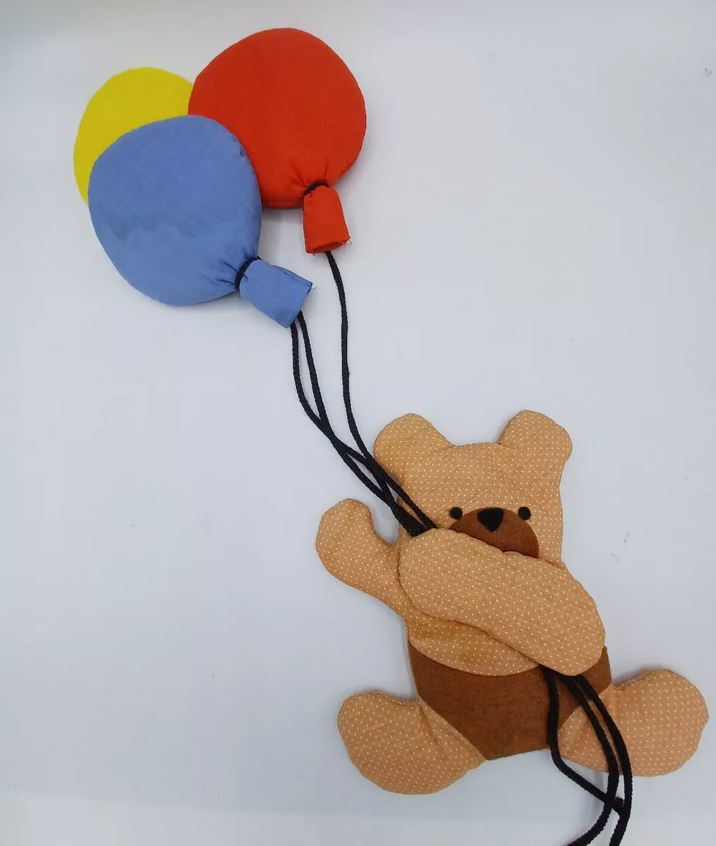 Teddy bear hanging from cheap balloons