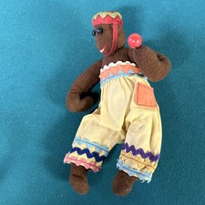 Vintage Stuffed Monkey Toy with Colorful Outfit and Red Ball