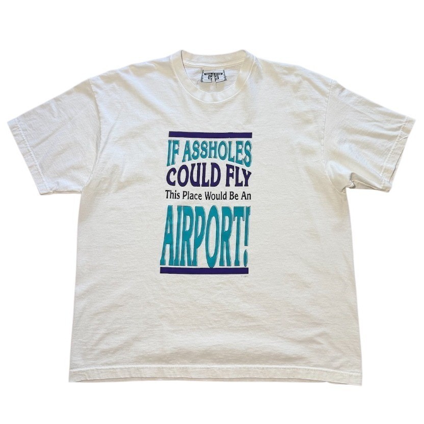 A genuine 90s airport/flying sarcasm graphic tee — the kind of deadpan humor that aged perfectly and can't be replicated by a print-on-demand shop.