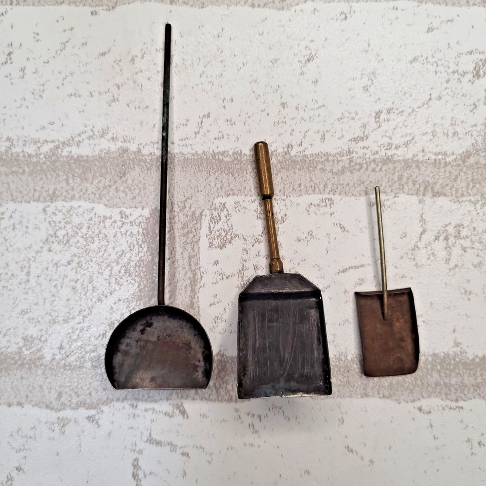 A miniature brass Tampico fireplace set — tiny shovel, scoop and all — repurposed as a whimsical MCM desk novelty.