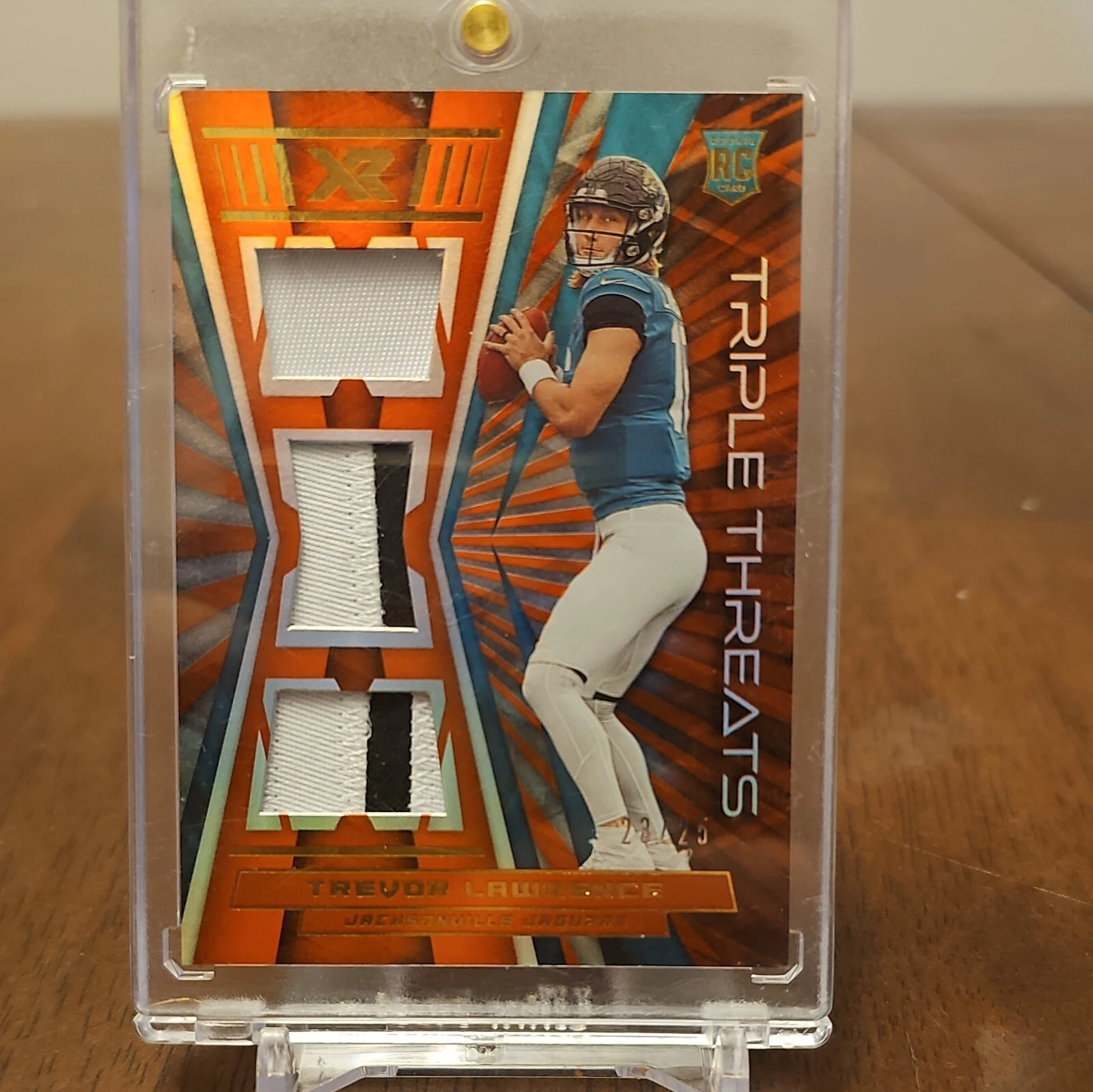 Trevor Lawrence Panini XR Rookie Triple Threats Materials #RTTTRL Orange