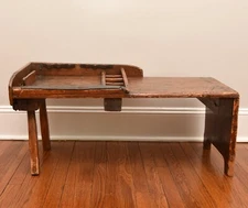 Antique cobblers bench with hand-wrought nails, bent metal bars, & leather strap