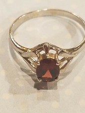 NATURAL GARNET, 5 X 7 oval set in solid sterling silver ring. Size 7
