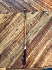 Vintage wooden shoehorn with capped figure