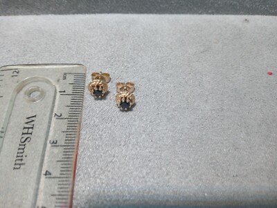 9 carat yellow gold hallmarked round single stone dark blue Sapphire earrings.