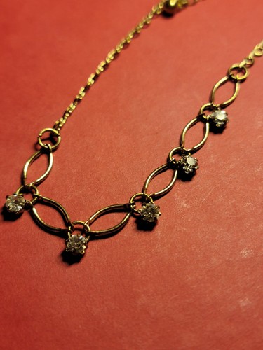 Vintage Avon Bracelet open pinched oval links light gold tone clear rhinestones.