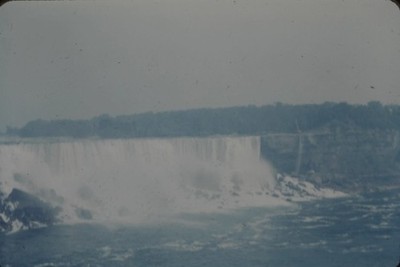RED BORDER SLIDE Wide, misty waterfall and turbulent river.