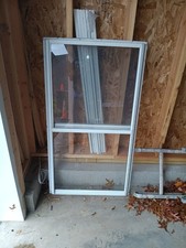 Used storm window , Screen included, 28×50 inches outside to outside.