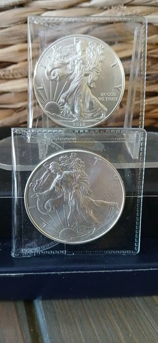 2 MINT SILVER EAGLES.....LOW START GOOD LUCK!!!!!!