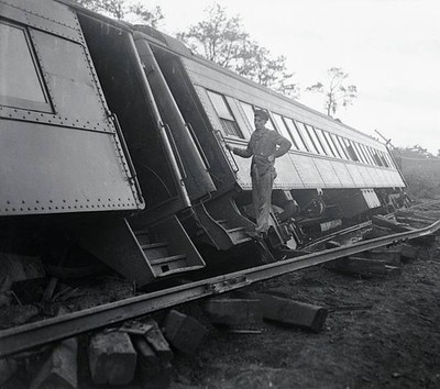 Trainman surveys damage done to a Long Island Railroad train after- Old Photo