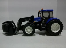 Bruder New Holland TG285 Tractor with loader/grapple and bale. No box.