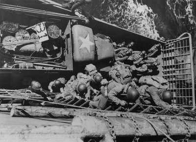 American soldiers scramble down from a heavy cargo ship onto a lan- Old Photo