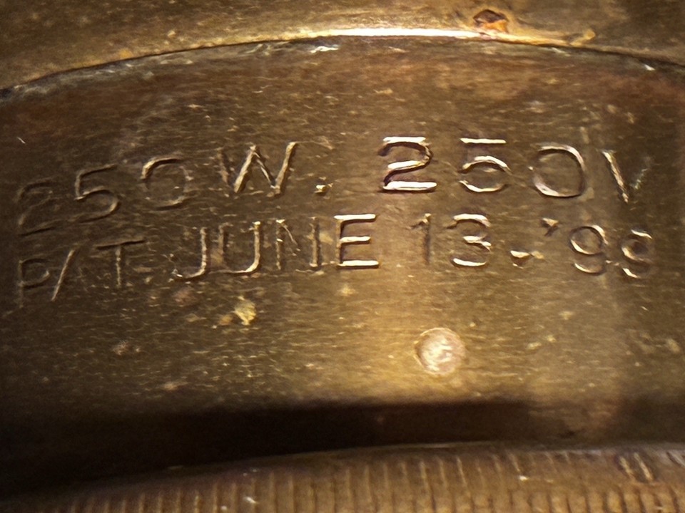 A patented 1899 industrial Faries brass banker's lamp with a parabolic eye-saver shade — a working piece of American industrial design history.
