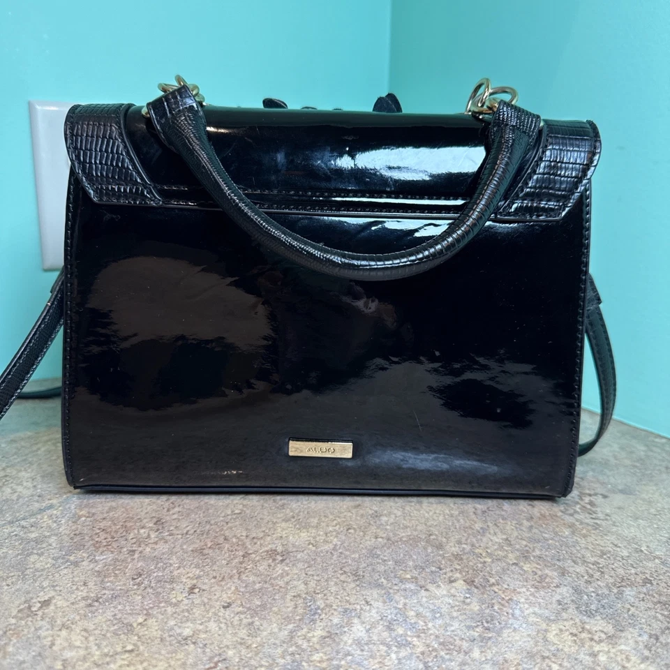 Monedero floral charol negro Aldo, herrajes dorados, tanto muñeca como bandolera  Foto 2 de 4