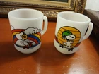 Set Of 2 Anchor Hocking Peanuts Skating Snoopy Milk Glass Vintage Mugs 4”
