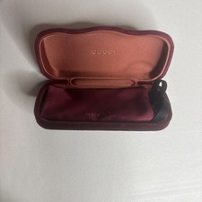 burgundy velvet Gucci sunglasses case with a gold logo on the interior lid