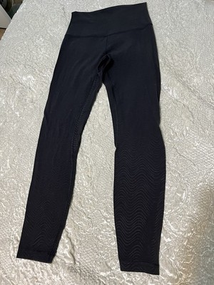Black Lululemon high-waisted leggings with black swirl print. Size 4