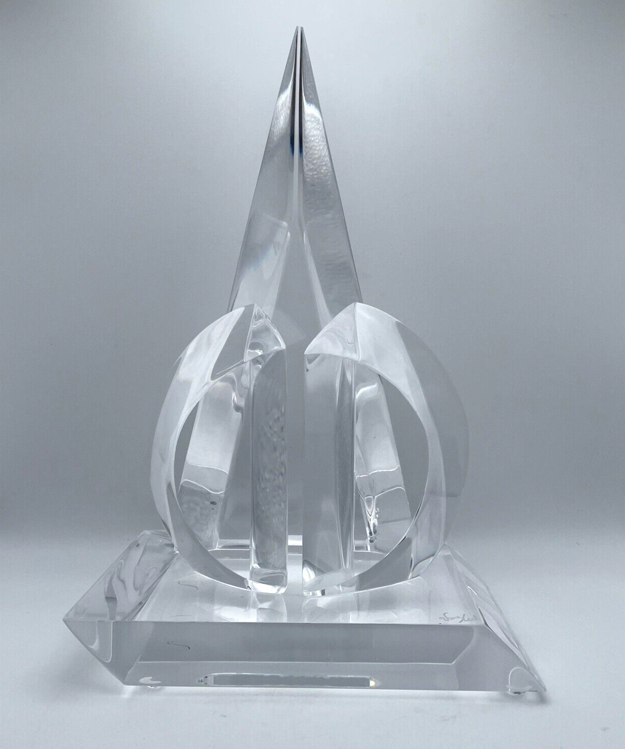 Clear lucite abstract sculpture with triangular and interlocking circular design, signed Van Teal