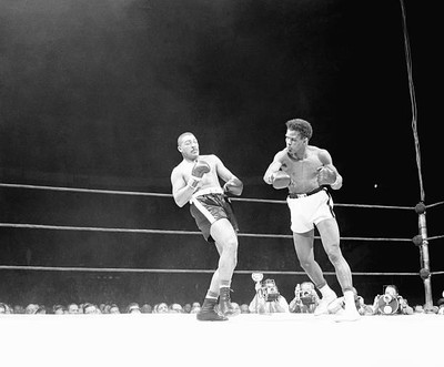 Big Bob Baker leans back to evade hurricane of blows from Tommy H- 1956 Photo