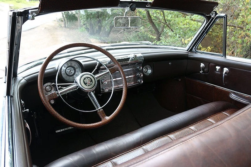 The leather looks distressed but it’s new, and the old window switches control modern electrics.