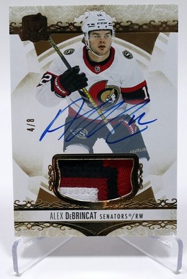 2022-23 Upper Deck The Cup Gold Foil Patch Auto Alex DeBrincat Wings Senators /8