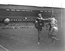 American Pete Dawkins kicks ball out of his hands as he is tackled- Old Photo