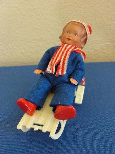 West Germany Vintage Wind Up Toy Boy/Girl on Sled