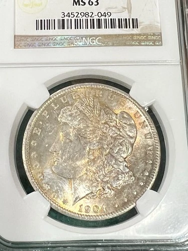 1904 O MORGAN UNCIRCULATED SILVER DOLLAR NGC MS63 WITH TONING