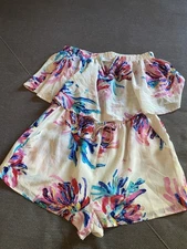 Charming floral romper by Yumi Kim. Features vibrant pink, blue, and cream hues.