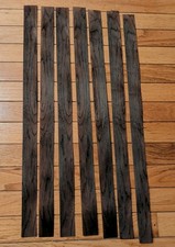 7 pieces of rosewood veneer 1 1/4" to 1 1/2" x 24 1/2" each raw 1/42"