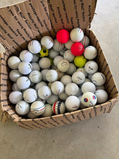 Box of all different types of golf balls. Used