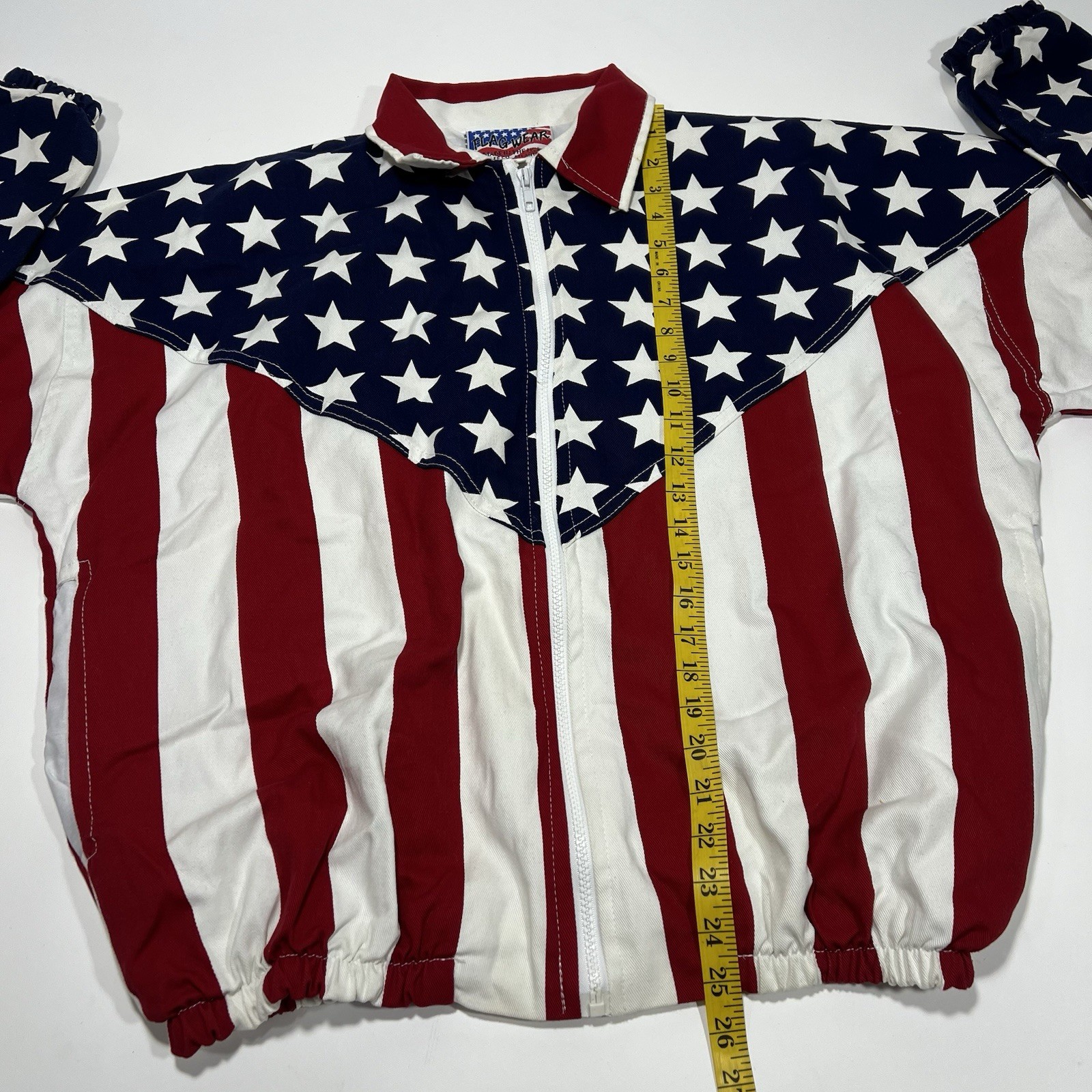 Red, white, and blue vintage jacket with American flag design featuring blue field with white stars and red and white horizontal stripes.