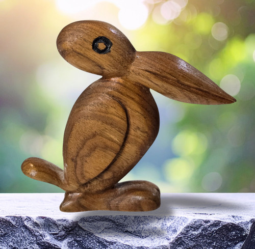 Hand carved wooden pelican with copper heart sculpture