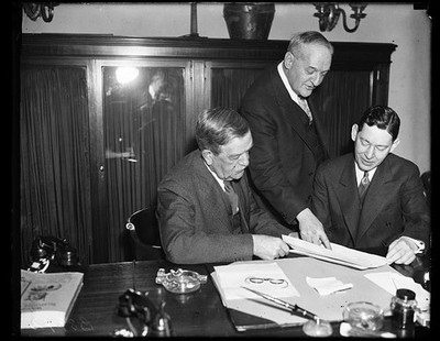 Photo:Ellison D. Smith 1930s Men Reviewing Document Office Scene
