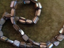 Mother-of-pearl shell chip natural color 15in strand, Per strand.
